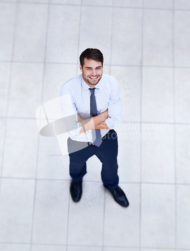 Image of Business, man and high angle portrait with arms crossed in office with confidence and pride. Above, entrepreneur and person in lobby to start morning in corporate London workplace with perspective