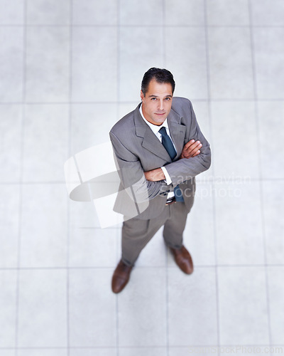 Image of Business, portrait and high angle of man with arms crossed in office with professional confidence and pride. Above, entrepreneur and person in lobby to start morning in London or corporate workplace