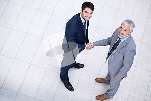 Image of Portrait, handshake and smile of business people with CEO for deal, collaboration or b2b partnership agreement for consultant. Top view, shaking hands or men in office for acquisition on mockup space