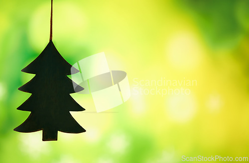 Image of Christmas, decoration and tree for holiday in studio isolated on a green background mockup space. Xmas, ornament and trinket hanging for festive tradition, party or Christian celebration in December
