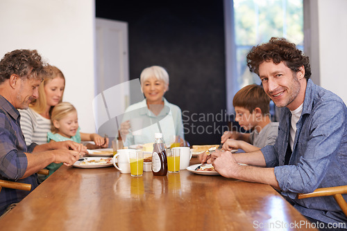 Image of Mature man, family and guest for breakfast at home on happiness in morning for bonding with conversation, support and care. Portrait, meal and eat with coffee in table to enjoy, fun and together.