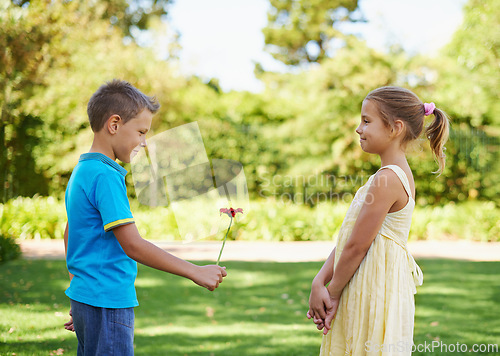 Image of Boy, girl and flower present or outdoor connection with love kindness for young friendship, bonding or innocent. Children, smile and backyard garden for giving gift for summer holiday, play or park