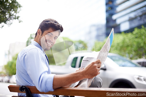 Image of Portrait, businessman and reading newspaper for information, daily news and updates on local events. Professional, male person and outdoor with smile for knowledge, stories and article in city