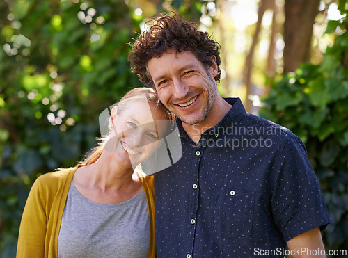 Image of Love, portrait and happy couple hug in a park for fun, bonding or vacation together in nature. Travel, face and people embrace in a forest with care, trust and support, fun or fresh air in Australia