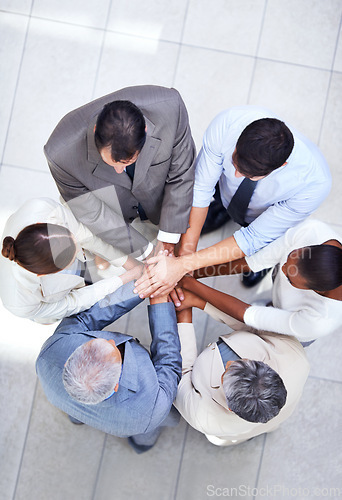 Image of Business people, together and huddle for hands in pile, community and support or unity. Colleagues, team and agreement in collaboration or alliance in workplace, solidarity and above for cooperation