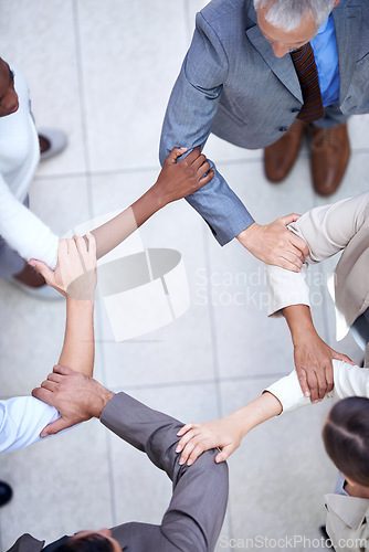 Image of Business people, above and arm circle in office in support for teamwork, collaboration or partnership. Corporate, solidarity or team with elbow link for mission unity, trust or workflow efficiency