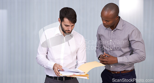 Image of Men, document or business in office, conversation or exchange of idea for planning, work or project. Businessmen, paper or point to discuss or explain for professional, corporate or teamwork