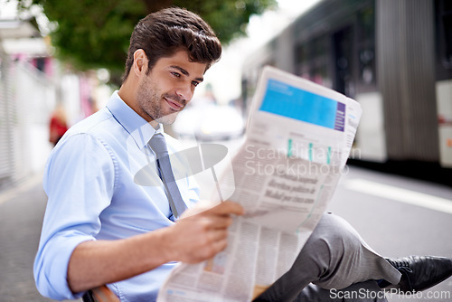 Image of Professional, businessman and reading newspaper for information, daily news and updates on local events. Outdoors, male person and smile with article for stories, journalism and newsletter in city