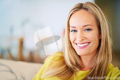 Image of Happy, portrait and woman relax on a sofa in a house with confidence, chilling or good mood at home. Face, smile and female person in a living room resting with free time, break or comfort on weekend