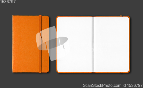 Image of Orange closed and open notebooks isolated on black