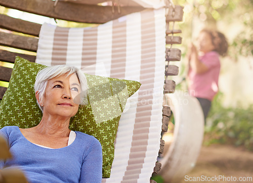 Image of Senior woman, think and garden with hammock to relax for retirement, break and enjoy. Bokeh, female person and.home with vision in summer or hot weather for outdoor and .satisfied with me time.