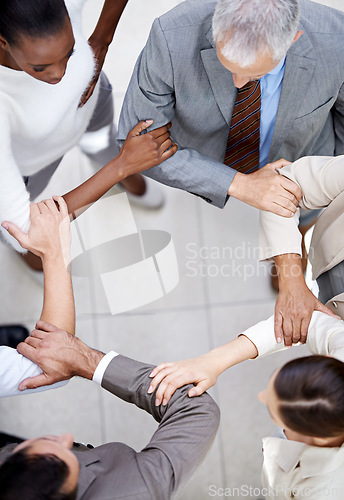 Image of Business people, top view and arm circle in office in support for teamwork, collaboration or partnership. Corporate, solidarity or team with elbow link for mission unity, trust or workflow efficiency