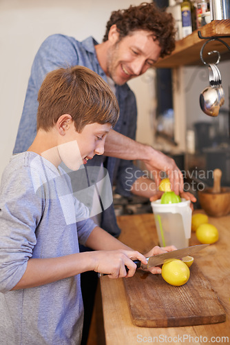 Image of Father, child and fruit for lemonade in home for nutrition on kitchen counter for breakfast, beverage or diet. Male person, son and juicer tool in apartment or fresh citrus, vitamin c or gut health