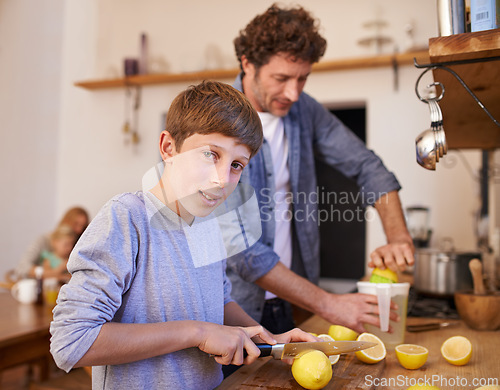 Image of Father, child and lemon juice or fruit in kitchen or lemonade preparation or healthy beverage, vitamin c or gut health. Son, portrait and male person with tool or family, drinking or ingredient