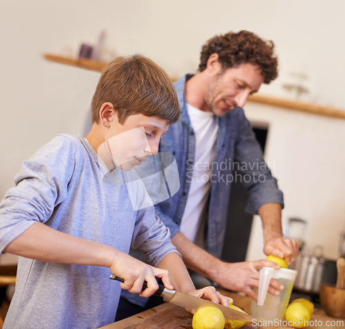 Image of Father, child and lemon fruit in kitchen for lemonade nutrition for breakfast drink, beverage or wellbeing. Male person, son and juicer equipment in apartment or fresh citrus, vitamin c or gut health