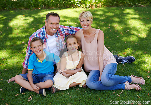 Image of Happy, portrait and family in garden of home with love and gratitude for parents and children. Mother, father and kids smile in backyard on holiday or vacation in summer and relax together on grass