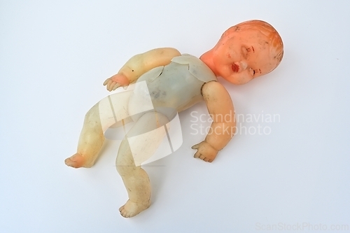 Image of old broken doll on a white