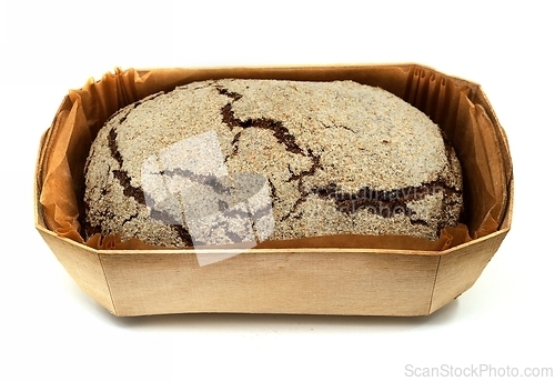 Image of loaf of fresh rye bread in a wooden box