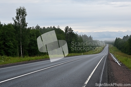 Image of empty country road on a foggy evening