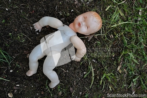 Image of old broken plastic doll 