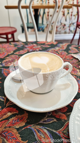 Image of A cup of coffee on white saucer