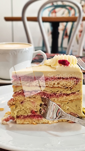 Image of A piece of cake on a plate with a fork