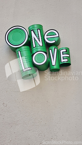 Image of Green one love sign on building