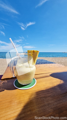 Image of Drink on wooden table by the ocean