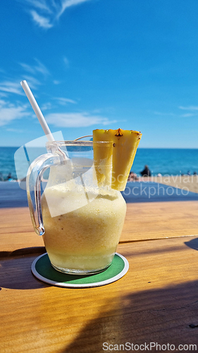Image of Pitcher of liquid on wooden table
