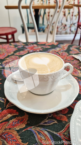 Image of A cup of coffee on white saucer