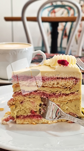 Image of A piece of cake on a plate with a fork