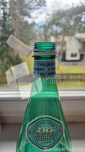 Image of TALLINN, ESTONIA - MAY 12, 2024: Close-up of a San Pellegrino bottle on a window sill. European Union directive aimed at reducing plastic waste