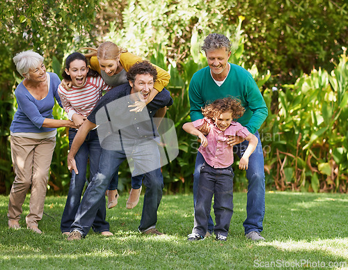 Image of Family, freedom and playing in outdoor nature, love and bonding together or happy in backyard. Generations, smile and laugh or game for humor in garden or park, vacation and summer holiday in France