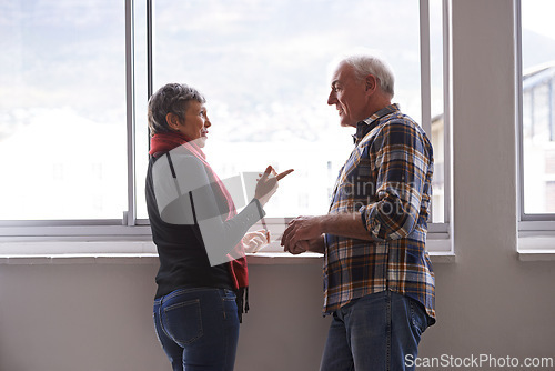 Image of Window, mature couple and communication with smile, conversation and discussion of retirement holiday. House, elderly people and marriage for bonding, commitment and planning for romantic vacation