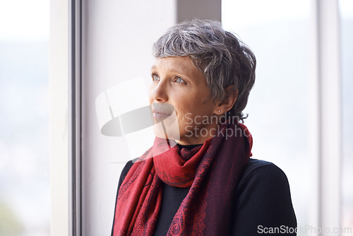 Image of Thinking, nostalgia and mature woman in window with memory, moment and reflection in home. Remember, face and elderly female in living room for thoughts, vision and feeling lonely in retirement