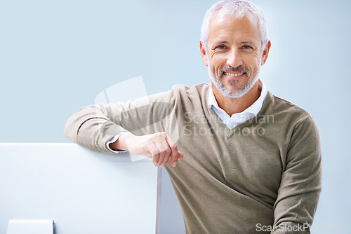 Image of Mature, businessman and portrait at computer for as boss for tech startup, entrepreneurship or small business. Male person, face and company development or employee, employment or blue background