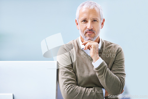 Image of Businessman, portrait and hand on chin in office for finance career, accounting and confidence. Mature employee, monitor and professional manager with pride for corporate job, company and work