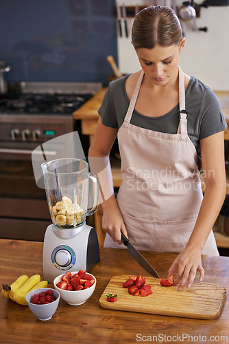 Image of Woman, fruit and blender for healthy smoothie in kitchen for weight loss nutrition, chopping board or ingredients. Female person, knife and preparation for vegan snack in apartment, organic or detox