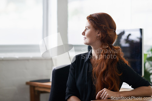 Image of Woman, office and think with vision at window for company idea, growth and hope with future in startup business. Female person, entrepreneur and desk with computer at work as hr for corporate.