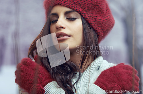 Image of Fashion, beauty and young woman with winter clothes on cold weather vacation or holiday. Serious, makeup and face of female person with gloves, jersey and beanie for trendy style for weekend trip.