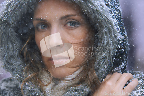 Image of Snow, woman and portrait in nature with cold climate and weather with winter fashion and idea. Ice, travel and freezing outdoor with a female person in Iceland with frost in a storm with jacket