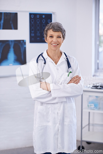 Image of Senior doctor, woman and arms crossed in portrait, radiology for surgery with anatomy scan and healthcare. Medical professional, treatment and surgeon in room for xray, medicine and confident expert