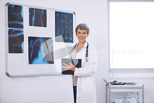 Image of Doctor, woman and clipboard in portrait, radiology for surgery with anatomy scan and healthcare. Senior medical professional, treatment and surgeon in room for xray, checklist and confident expert