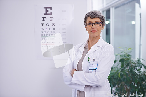 Image of Letter, chart and woman with optometrist for eye exam, arms crossed with confidence and senior doctor at clinic. Alphabet, glasses for vision and prescription lens with assessment and ophthalmology