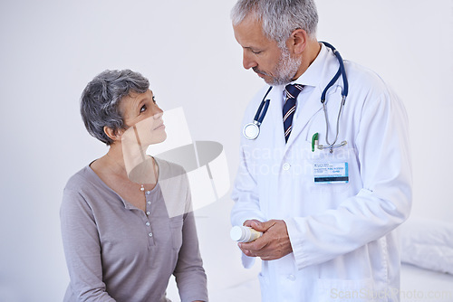 Image of Hospital, consulting and doctor with pills for patient for prescription, medicine and treatment. Healthcare, medication and senior woman in consultation for medical service, wellness and diagnosis