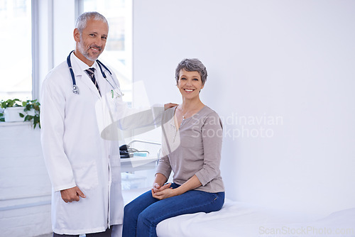 Image of Hospital, portrait and senior woman with doctor in a consultation room for examination, results or help. Healthcare, face and elderly patient consulting health expert for medical, support and advice