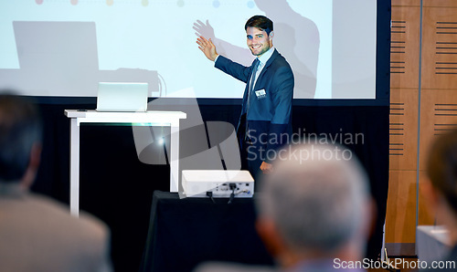 Image of Business man, podium and presentation, point at projector screen at conference or workshop with laptop for PPT. Corporate training, seminar and speaker with info, audience and professional speech