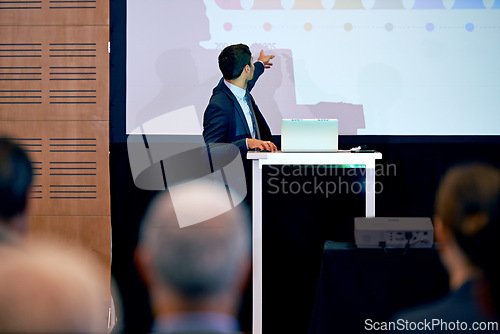 Image of Business man, presentation and point at projector screen, conference or workshop with laptop for slideshow or PPT. Corporate training, seminar and speaker with info, audience and professional speech