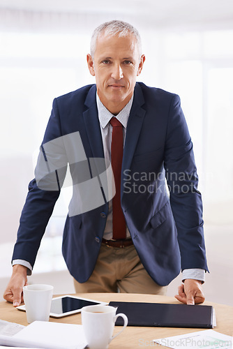 Image of Serious, office and portrait of business man with confidence for career, job and working. Professional, corporate agency and senior person at desk for company pride, startup and entrepreneurship