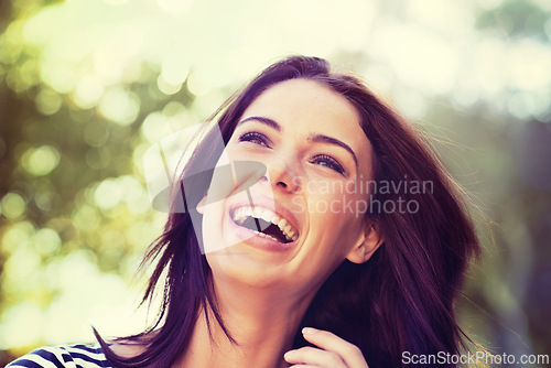 Image of Woman, smile and laugh with nature, sunshine and park for happiness and wellness. Person, joy and bokeh with closeup, glow and beauty for summer relax and adventure outside in garden with trees